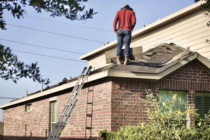 Professional roofer working on a residential roof in Lucernemines
